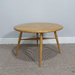 A Retro 1970s Ercol vintage drop leaf circular coffee Table, raised on tapered legs with chamfered
