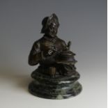 A late 19thC novelty Bronze Desk / Ink Stand, in the form of a jovial man with a bottle under one