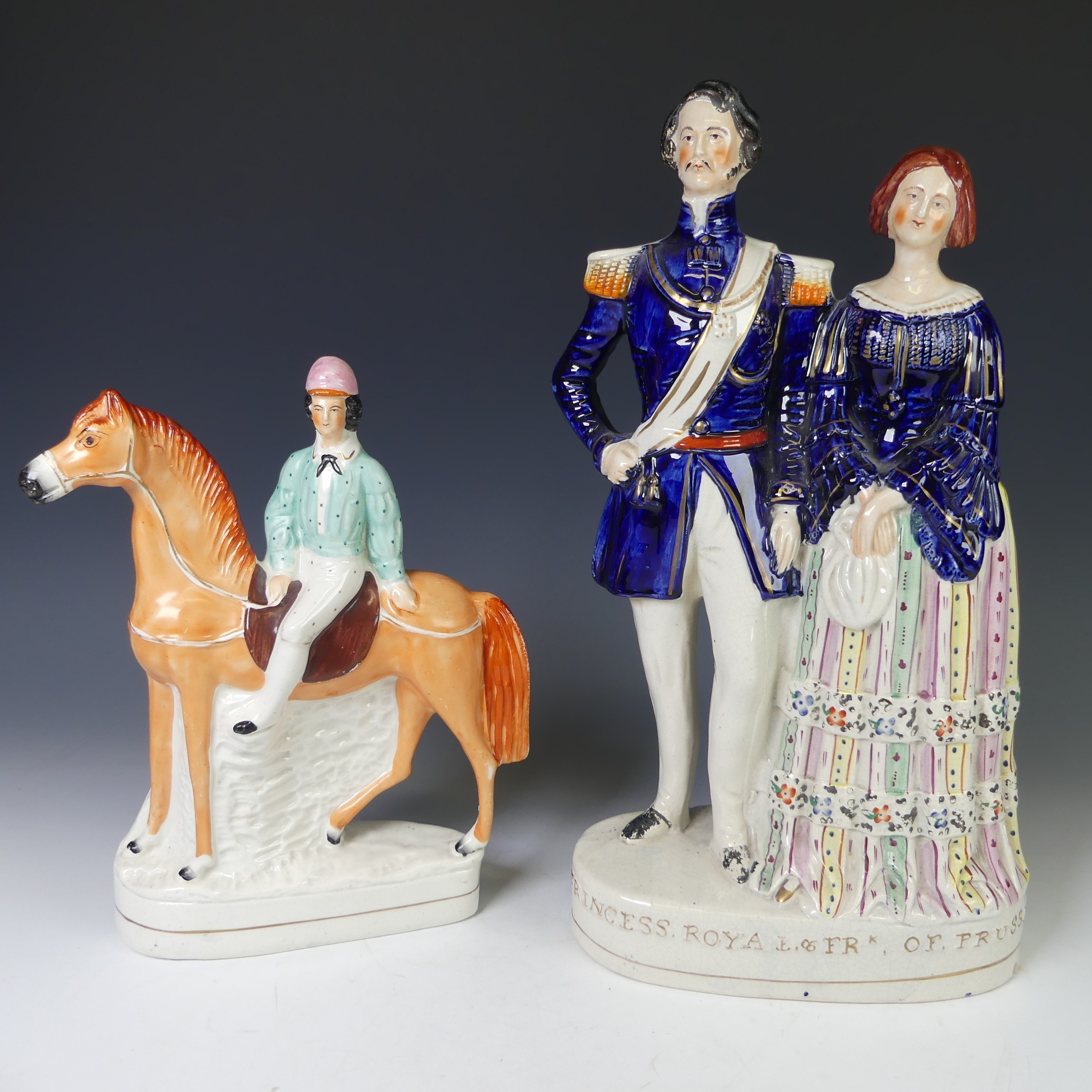 An antique Staffordshire pottery figure of a Jockey on Horseback, the rider with pink hat and blue