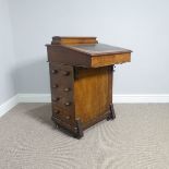 A Victorian inlaid walnut Davenport, the top with hinged desk organiser, above a sloped lid, and the