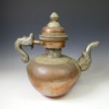 A large Tibetan copper Tea Pot, with white metal mounts, the handle and spout modelled as a mythical