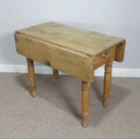A Victorian drop leaf pine Kitchen Table, raised on turned legs, one leg damaged, W 50 cm x H 73.5