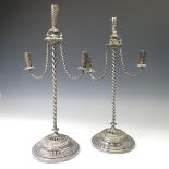 A pair of Continental silver plated Candlesticks, with narrow twisted columns and circular pierced