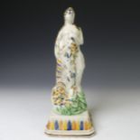 An early 19thC prattware figure of Flora, or the season of Spring, depicted wearing classical