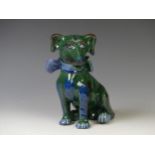 An early 20thC C. H. Brannam glazed figure of a Dog, of green ground, modelled with collar and