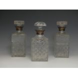 A pair of silver-collared cut glass Decanters, by C J Vander, hallmarked London, 1969, together with