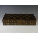 An early 19thC Chinese export lacquer rectangular games box, decorated in gilt with a chess board,