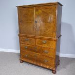 A Queen Anne style Cabinet on Chest, with associated top, top section enclosing fitted interior, oak