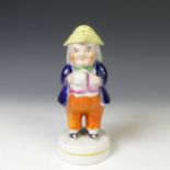 A Staffordshire pottery group 'Going to the Market', together with a Staffordhsire figure of a