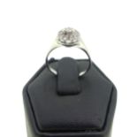 A diamond cluster Ring, the central brilliant cut stone approx. 0.06ct six claw set high above a