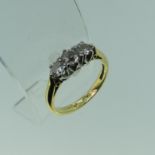 A three stone diamond Ring, the central stone approx. 3.5ct, with a smaller stone on either side,