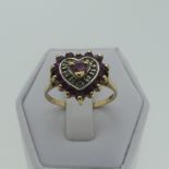 A ruby and diamond heart shaped Ring, all mounted in 9ct yellow gold, Size N, 2.1g.