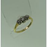 A small three-stone diamond Ring, the centre stone approx. 0.17ct, mounted in 18ct yellow gold and