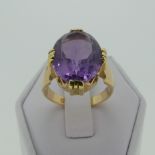 An amethyst Dress Ring, the oval facetted stone 15mm long, mounted in 18ct yellow gold, Size M, 7.
