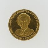 A 9ct gold Margaret Thatcher 'Britain's First Lady Prime Minister' commemorative Coin Token, dated