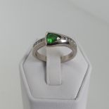 A modernist tsavorite and diamond Ring, the trilliant cut stone approx 4.6mm long, collet set with