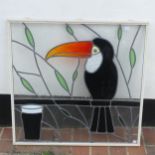 A stained glass Window in the style of Guinness, with Toucan perched beside a glass of stout, H:75cm