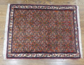 Tribal Rugs; a small dark rust ground Persian Herati rug, of high quality, with finely knotted