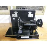 An early 20thC Singer Featherweight Sewing Machine, model 221K, in fitted black case, complete
