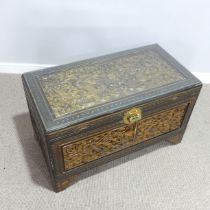 A Chinese heavily carved camphorwood Chest, with removable glass top, W 101 cm x H 59 cm x D 52 cm