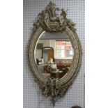 A giltwood and gesso oval girondelle wall Mirror, with candle holders, H 113 cm x W 60 cm.