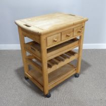 A Modern pine Butchers Block, raised on casters, W 75 cm x H 85 cm x D 53 cm.