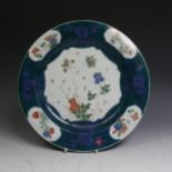 An antique Chinese porcelain Plate, with decorative floral enamels, enclosed within powder blue