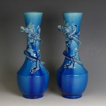 A matched pair of 20thC blue Awaji Japanese pottery Vases, of bottle form, with dragon in relief