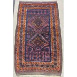 Tribal Rugs; an old Afghan Rug, plum coloured ground with geometric patterned dark orange border,