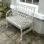 A Georgian style painted metal garden Seat, the back and arm panels with Gothic style open work