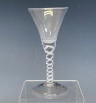 A Georgian Wine Glass, with trumpet bowl and opaque twist stem on conical foot, 16cm high, together