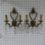 A pair of early 20thC gilt brass two branch Wall Sconces, adorned with crystal glass drops, H34cm