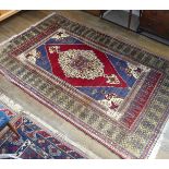 Tribal Rugs; an old Turkish Yahyali Rug, blue and red ground with cream central medallion, within