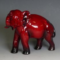 A Royal Doulton red flambe figure of an Elephant, trunk in reared position and blue colouration to