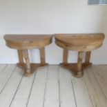 A Pair of Victorian pine demi-lune console Tables, raised on three legs the central with