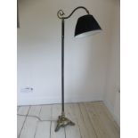 An Edwardian brassed metal standard Lamp, with black shade raised on tripod base, H 167 cm.