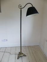 An Edwardian brassed metal standard Lamp, with black shade raised on tripod base, H 167 cm.