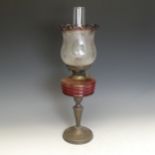 A Victorian Oil Lamp, cranberry reservoir and etched shade, H 58 cm.