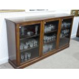 A large Victorian mahogany Bookcase, with three glazed cupboard doors, enclosing three shelves, on