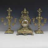 A 19th Century French gilt brass Clock Garniture, including a pair of three-light candelabra, the