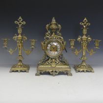 A 19th Century French gilt brass Clock Garniture, including a pair of three-light candelabra, the