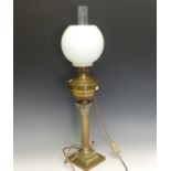 A 19thC French brass corinthian column oil Lamp, converted to electricity, H 73 cm.