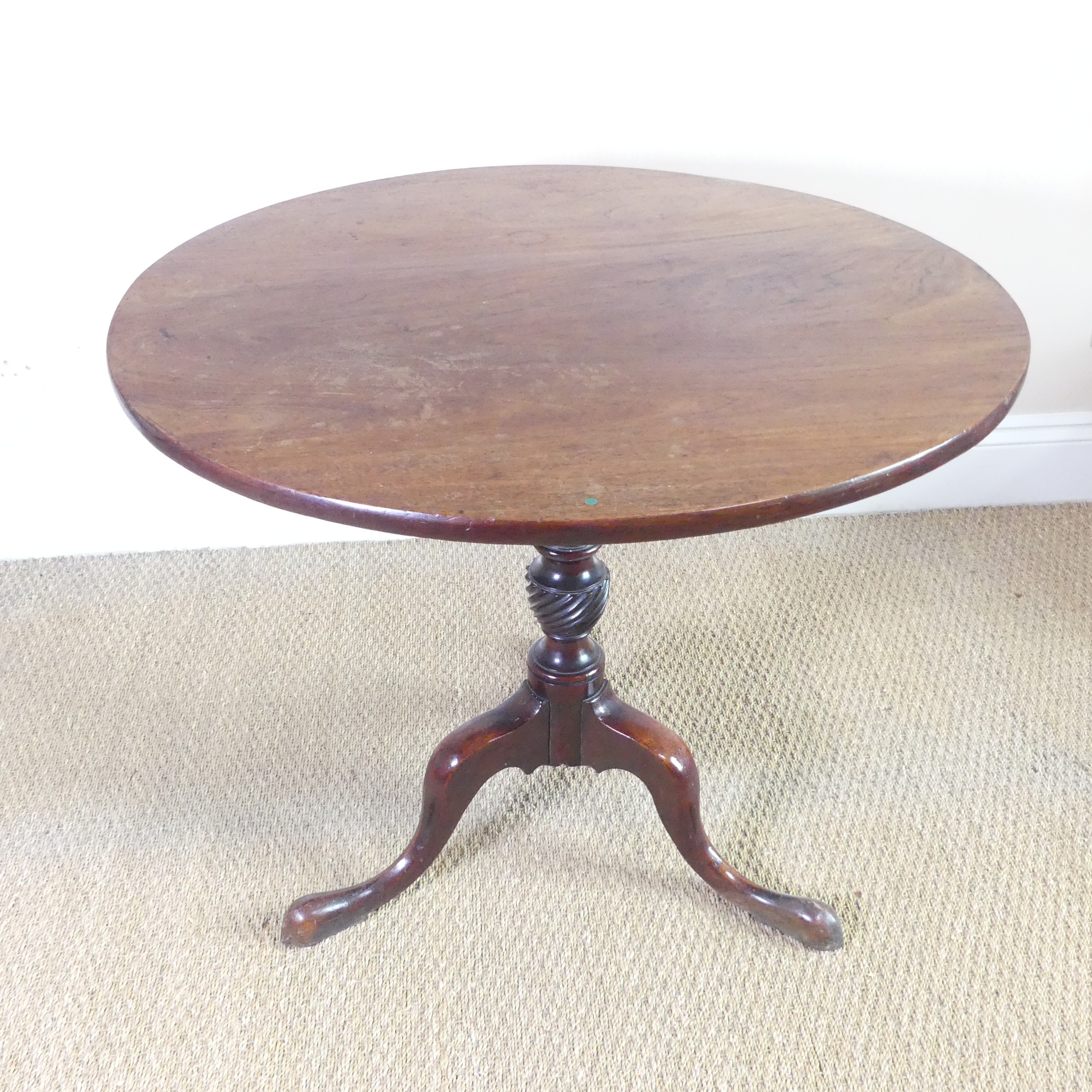 A large Georgian mahogany tilt top circular wine Table, raised on turned column and tripod legs, W