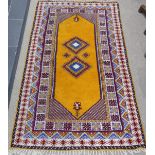 Tribal Rugs; a vintage yellow ground Rug, possibly Moroccan, with two central medallions and wide