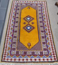 Tribal Rugs; a vintage yellow ground Rug, possibly Moroccan, with two central medallions and wide