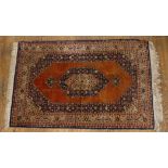 Tribal Rugs; an old Persian finely knotted 100% silk rug, burnt orange ground with dark blue