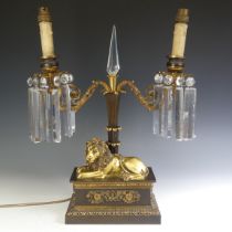 A 19thC gilt-bronze two-branch Candelabra with Lion as base, converted to electricity, W 40 cm x H