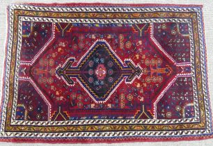 Tribal Rugs; a Persian Qashqai Rug, red ground, thick wool pile on cotton base, worn along one edge,