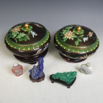 A pair of 20thC Chinese cloissone lidded Pots, with black ground and floral motifs, both raised on