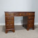 A Georgian style mahogany twin Pedestal Desk, top inset with gilt brown tooled leather writing